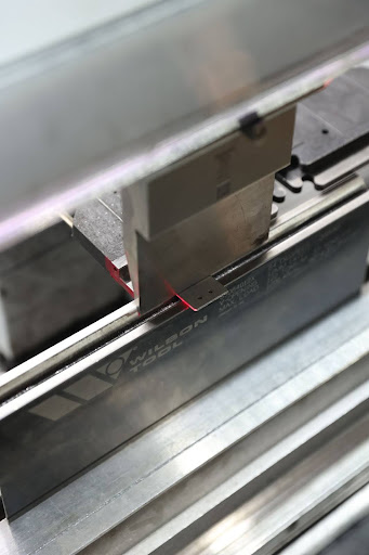 CNC Press Brake - Sheet Metal Bending Sheet metal being formed in a CNC press brake with Wilson Tool die